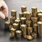 Rich man stacking golden money coins. Income saving plan.