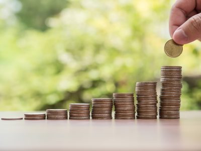 Saving money concept . hand putting money coin stack