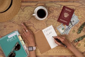 Planning vacation, travel plan, trip vacation using world map with accessories. Top view, flat lay.