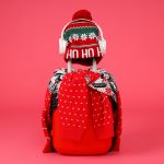 A suitcase with a sweater, a hat and headphones