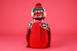 A suitcase with a sweater, a hat and headphones