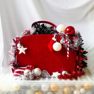 Red suitcase with Christmas ornaments and space for text