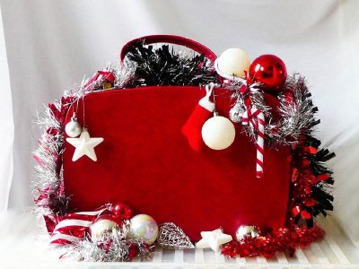 Red suitcase with Christmas ornaments and space for text