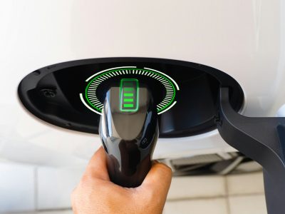 Electric car or ev is charging at station .